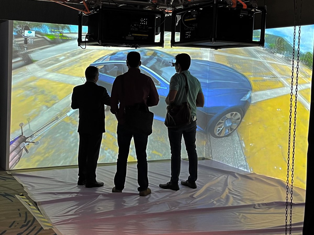three-engineers-in-a-corner-VR-CAVE-interacting-with-a-complex-3D-model-of-a-car