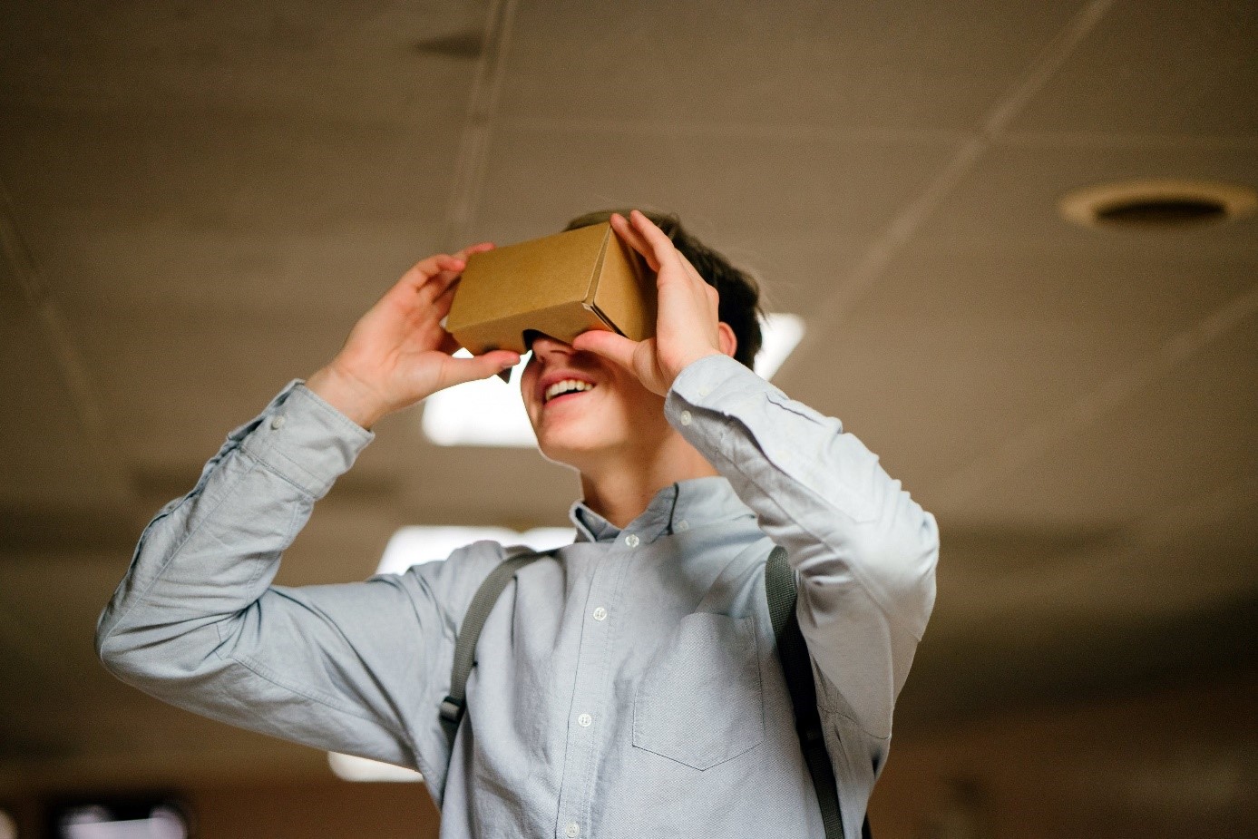 Man using Google Cardboard VR headset