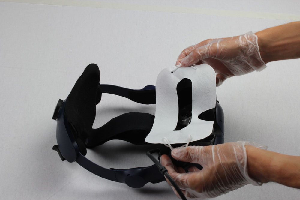hands with gloves cleaning vr headset